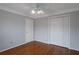 Relaxing bedroom featuring hardwood floors, ceiling fan and large closet at 2157 Brandon Lee Sw Dr, Marietta, GA 30008