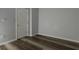 A tranquil bedroom has stylish plank flooring and a white door for closet access at 2157 Brandon Lee Sw Dr, Marietta, GA 30008