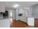 Well-lit kitchen featuring white cabinets, an island, and hardwood floors at 2157 Brandon Lee Sw Dr, Marietta, GA 30008