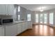 Open kitchen with white cabinets, hardwood floors, and a view of the living area at 2157 Brandon Lee Sw Dr, Marietta, GA 30008
