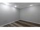 A neutrally painted room is complemented by plank flooring and recessed lighting at 2157 Brandon Lee Sw Dr, Marietta, GA 30008