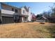 Grassy backyard with a hot tub, outdoor seating area, and firepit with space for entertaining or relaxation at 3519 Wellsley Dr, Powder Springs, GA 30127