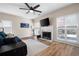 Cozy living room with hardwood floors, fireplace, and large windows offering plenty of natural light at 3519 Wellsley Dr, Powder Springs, GA 30127