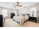 Spacious main bedroom with tray ceiling and a ceiling fan above a large, comfortable bed at 3519 Wellsley Dr, Powder Springs, GA 30127
