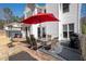 A backyard patio seating area featuring table, chairs, umbrella, grill, and adjacent hot tub, ideal for outdoor living and entertaining at 3519 Wellsley Dr, Powder Springs, GA 30127