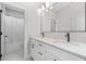 Bathroom featuring dual vanity with black faucets, large mirror, tub, and shower at 410 Ward Farm Dr, Powder Springs, GA 30127