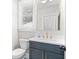 Stylish powder room with a modern vanity, gold fixtures, and a framed mirror at 410 Ward Farm Dr, Powder Springs, GA 30127