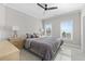Bright bedroom offers a comfortable queen bed, ceiling fan, and natural light from two windows at 410 Ward Farm Dr, Powder Springs, GA 30127