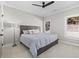Neutral bedroom featuring a comfortable queen bed with stylish decor and a ceiling fan at 410 Ward Farm Dr, Powder Springs, GA 30127