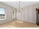 Elegant dining room with decorative molding on the walls, hardwood floors, and modern light fixture at 410 Ward Farm Dr, Powder Springs, GA 30127