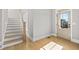 Bright entryway featuring hardwood floors, stairs with a light wood banister and a window with great natural light at 410 Ward Farm Dr, Powder Springs, GA 30127