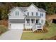 Beautiful two-story home with attached garage and inviting front porch at 410 Ward Farm Dr, Powder Springs, GA 30127