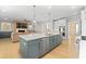 Well-lit open-concept kitchen with stainless steel appliances, hardwood floors, and seamless connection to living spaces at 410 Ward Farm Dr, Powder Springs, GA 30127