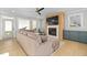 Comfortable living room with fireplace, built-ins, ceiling fan, and seamless access to the outside at 410 Ward Farm Dr, Powder Springs, GA 30127