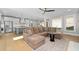 Open-concept living room with stainless steel appliances, modern kitchen, and a large comfortable sectional couch at 410 Ward Farm Dr, Powder Springs, GA 30127