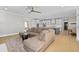 Spacious living room connects to the kitchen and features hardwood floors, modern lighting, and lots of windows at 410 Ward Farm Dr, Powder Springs, GA 30127