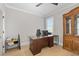 Office with a large desk, wood floors, crown molding, and a storage cabinet at 410 Ward Farm Dr, Powder Springs, GA 30127