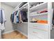 Well-organized walk-in closet with ample shelving and storage drawers, keeping clothes tidy at 410 Ward Farm Dr, Powder Springs, GA 30127