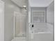 A clean bathroom with a bathtub, shower, and nice light at 7104 Secret Rose, Douglasville, GA 30134