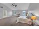 A large bedroom with two windows, ceiling fan, and large bed at 7104 Secret Rose, Douglasville, GA 30134