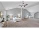 Primary bedroom with vaulted ceiling, gray walls, and a seating area at 7104 Secret Rose, Douglasville, GA 30134