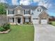 Charming two-story home featuring a brick and siding facade and a well-manicured front yard at 7104 Secret Rose, Douglasville, GA 30134