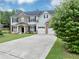 Suburban home featuring a brick and siding facade and a long concrete driveway at 7104 Secret Rose, Douglasville, GA 30134
