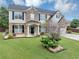 Two-story home featuring a brick and siding facade and a well-manicured front yard at 7104 Secret Rose, Douglasville, GA 30134
