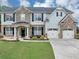 Attractive home featuring a brick and siding facade and a well-manicured front yard at 7104 Secret Rose, Douglasville, GA 30134