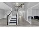 Spacious foyer features a staircase with black and white rails and hardwood floors at 7104 Secret Rose, Douglasville, GA 30134