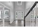 Light-filled foyer with high ceilings, wood-look floors, and staircase with white railings at 7104 Secret Rose, Douglasville, GA 30134
