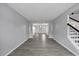 Spacious living room with hardwood floors, large windows, and staircase at 7104 Secret Rose, Douglasville, GA 30134