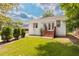 White brick home's backyard with lush green lawn and mature trees at 937 Rosedale Ne Rd, Atlanta, GA 30306