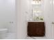 Chic bathroom with a wooden vanity, a stylish mirror, and a toilet area to the side at 937 Rosedale Ne Rd, Atlanta, GA 30306