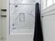 Modern tub and shower with beautiful marble and a window for natural light at 937 Rosedale Ne Rd, Atlanta, GA 30306