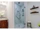 Stylish bathroom with a marble shower, wood vanity, and floating shelves for storage at 937 Rosedale Ne Rd, Atlanta, GA 30306