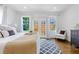 Sun-filled bedroom with a comfortable bed, backyard access, and stylish decor with an accent rug at 937 Rosedale Ne Rd, Atlanta, GA 30306