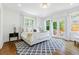 Bright bedroom with white walls, hardwood floors, a modern rug, and a door leading to a deck at 937 Rosedale Ne Rd, Atlanta, GA 30306