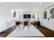 Open dining room with modern chairs, decorative fireplace and view to front entry at 937 Rosedale Ne Rd, Atlanta, GA 30306