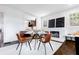 Sunlit dining room with modern chairs, fireplace and view to kitchen at 937 Rosedale Ne Rd, Atlanta, GA 30306