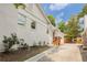 Exterior side view of a charming white brick home with a landscaped yard and wooden steps at 937 Rosedale Ne Rd, Atlanta, GA 30306