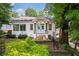 Charming white home featuring a welcoming light blue entry door and beautifully landscaped front yard at 937 Rosedale Ne Rd, Atlanta, GA 30306