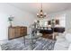 Open-concept living room connected to a kitchen, featuring hardwood floors and designer lighting at 937 Rosedale Ne Rd, Atlanta, GA 30306