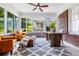 Sunroom with brick walls, large windows, two leather chairs, an ottoman, and a patterned rug at 937 Rosedale Ne Rd, Atlanta, GA 30306