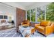 Sunroom with brick walls, two leather chairs, an ottoman, and a patterned rug at 937 Rosedale Ne Rd, Atlanta, GA 30306