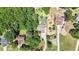 Aerial shot of the property highlighting its lush surroundings, mature trees, and neighboring homes at 34 Laurel Ne Way, White, GA 30184