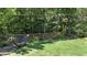 Relaxing backyard with lush lawn, string lights, hammock, and a fenced perimeter for added privacy at 34 Laurel Ne Way, White, GA 30184