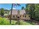 Well-maintained backyard with a cozy deck, string lights, mature trees, and a fenced perimeter at 34 Laurel Ne Way, White, GA 30184
