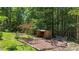 Backyard featuring a cozy fire pit area surrounded by lush greenery and mature trees at 34 Laurel Ne Way, White, GA 30184