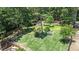 Expansive backyard with lush landscaping, mature trees, fenced yard, and tranquil green space at 34 Laurel Ne Way, White, GA 30184